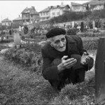 old man in beret at grave