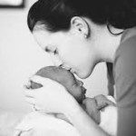 mom kissing infant