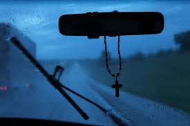 cross hanging from car mirror