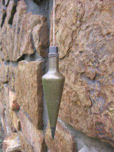 plumb line hanging next to a wall
