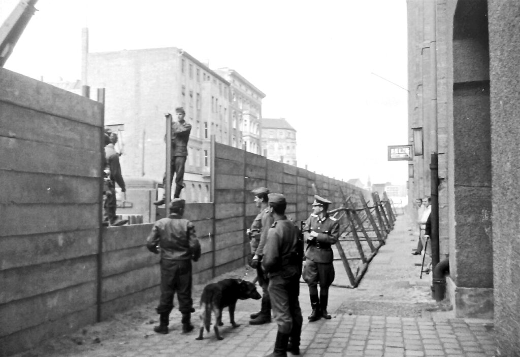 Soviets building the Berlin Wall to isolate East Berlin from the British, French and US sections of West Berlin 